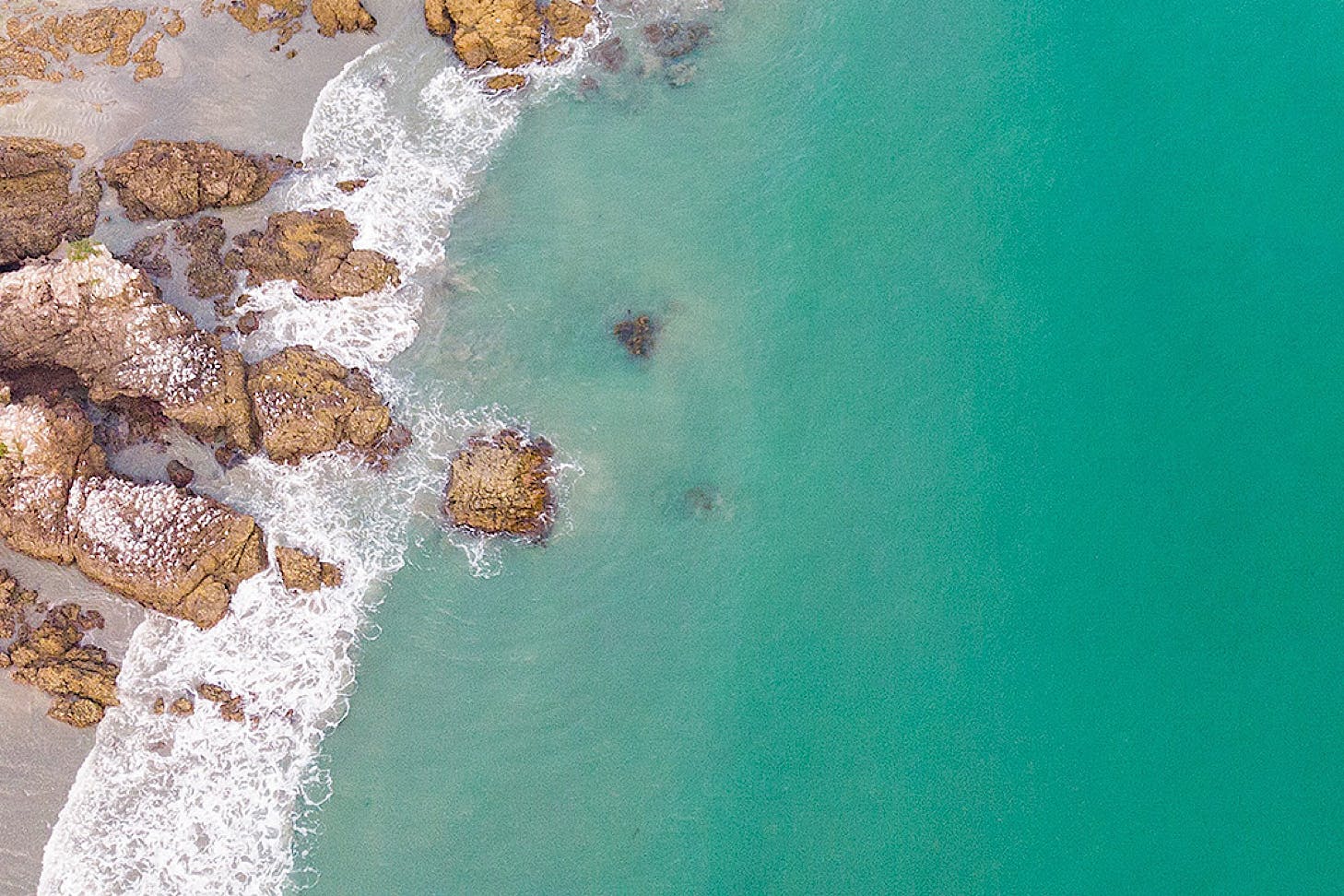 Striking blue waters and a perfect beach, reminiscent of a tropical island.